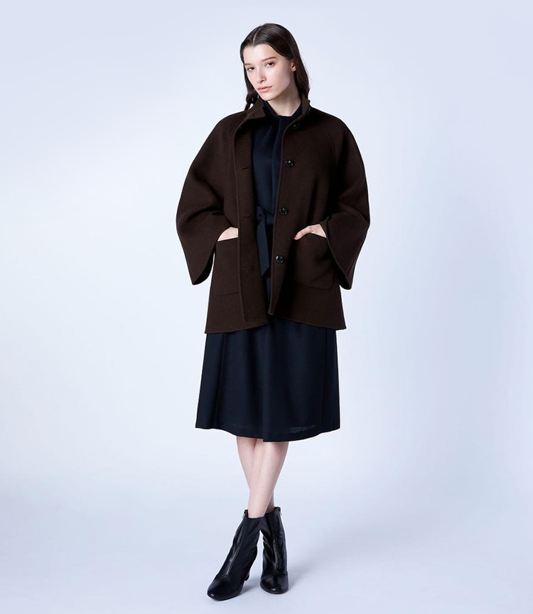 ダークブラウンのライトリバーコートを着た女性